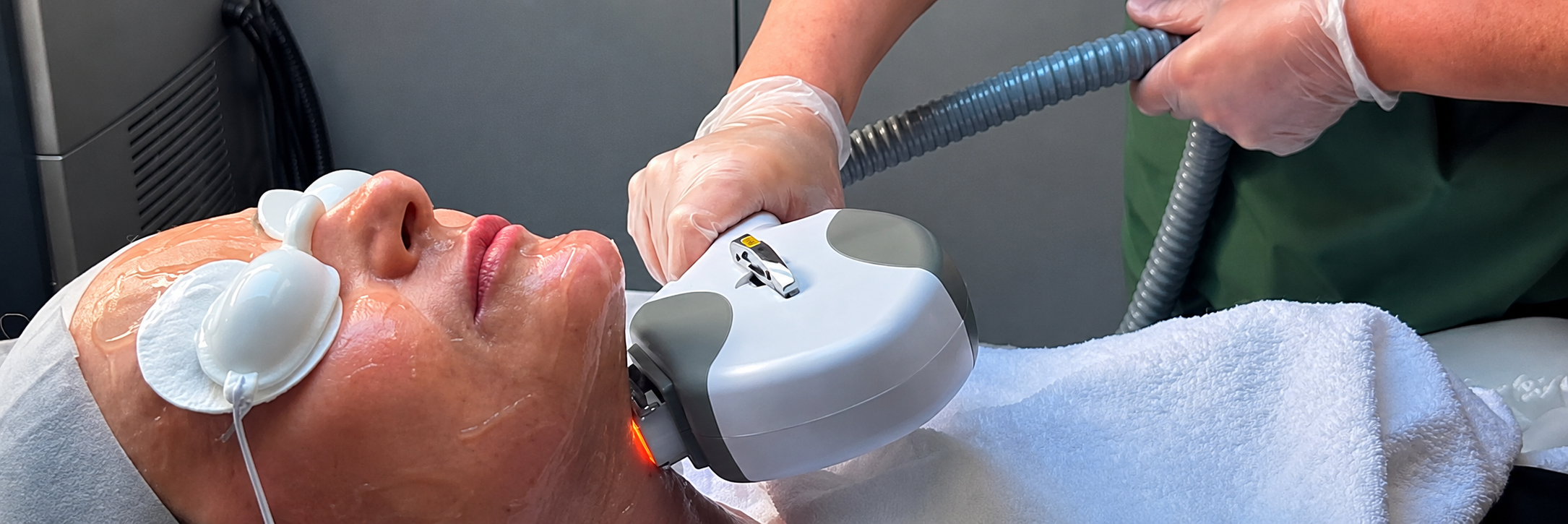 Woman receiving a professional facial treatment in a clinic.