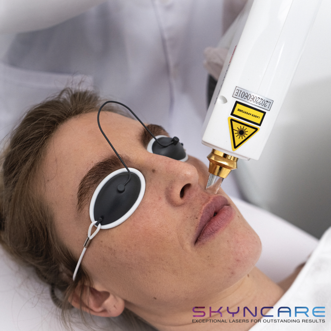 Woman receiving professional laser hair removal treatment on her legs